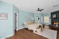 705 Swann Street, Wilmington, NC 28401 — 3-bedroom home in Brooklyn, Wilmington, NC, photo 23 of 67: Cozy Coastal Bedroom with Fireplace Glow