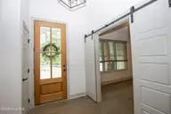 102 Greystones Court, Pinehurst, NC 28374 — 4-bedroom home in National, Pinehurst, NC, photo 5 of 55: Foyer and barn door to office