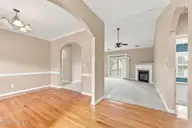 112 White Heron Lane, Swansboro, NC 28584 — 3-bedroom waterfront home in Bluewater Cove, Swansboro, NC, photo 6 of 60: dining into living room