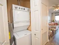 9100 Reed Drive 3202, Emerald Isle, NC 28594 — 1-bedroom waterfront condo in Queens Court, Emerald Isle, NC, photo 23 of 52: Stack washer/dryer