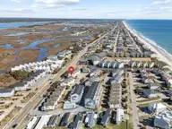 828 /102 N New River Drive 102, Surf City, NC 28445 — 4-bedroom waterfront townhome in Carolina Shores, Surf City, NC, photo 2 of 39: 55-web-or-mls-DJI_20260224111708_0995_D