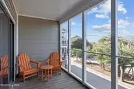 590 Marina Drive E-5, Pine Knoll Shores, NC 28512 — 3-bedroom waterfront condo in Beacon's Reach, Pine Knoll Shores, NC, photo 6 of 31: screened porch off living/bedroom