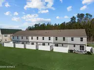 3404 Penguin Circle, Elizabeth City, NC 27909 — 3-bedroom townhome in Adams Landing, Elizabeth City, NC, photo 2 of 17: Poplar Rear Exterior