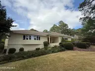 88 Mcmichael Drive, Pinehurst, NC 28374 — 3-bedroom home in Pinewild CC, Pinehurst, NC, photo 1 of 70: Front