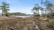 104 W High Bluff Drive, Hampstead, NC 28443 — 3-bedroom waterfront home in Pelican Reef, Hampstead, NC, photo 8 of 63: 48_dji_20260302111647_0037_d