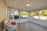 332 Foxhall Road, Newport, NC 28570 — 3-bedroom home in Sand Ridge, Newport, NC, photo 20 of 45: Rear Screened Patio