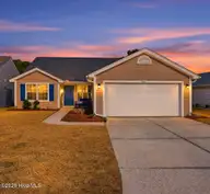 952 Wyndfall Drive SW, Sunset Beach, NC 28468 — 3-bedroom home in Wyndfall, Sunset Beach, NC, photo 1 of 41: AI Sunset example