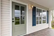 4930 N Hampton Drive SE, Southport, NC 28461 — 3-bedroom waterfront home in Carolina Place, Southport, NC, photo 5 of 58: Front porch