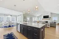 109 Ocean Bluff Drive, Indian Beach, NC 28512 — 6-bedroom waterfront home in Ocean Bluff, Indian Beach, NC, photo 18 of 57: Kitchen, Dining, and Living Room