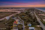 109 Old Village Lane, North Topsail Beach, NC 28460 — 8-bedroom waterfront home in The Village of Stump Sound, North Topsail Beach, NC, photo 3 of 73: 109OldVillage_Aerial_01_Dusk_02