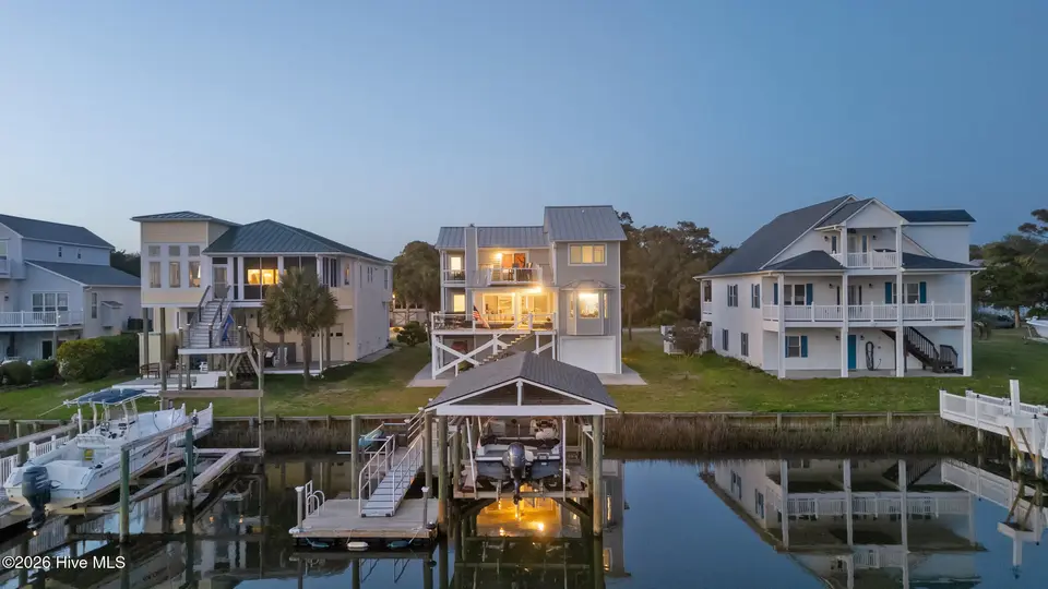 103 E Island Drive, Oak Island, NC 28465 — 3-bedroom waterfront home, Oak Island, NC, photo 1 of 76: 84_twilight