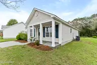 4930 N Hampton Drive SE, Southport, NC 28461 — 3-bedroom waterfront home in Carolina Place, Southport, NC, photo 3 of 58: Side view