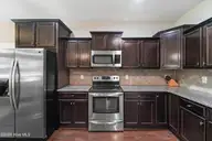 134 Mittams Point Drive, Jacksonville, NC 28546 — 3-bedroom home in Towne Pointe, Jacksonville, NC, photo 18 of 40: KITCHEN-FRIDGE-STOVE