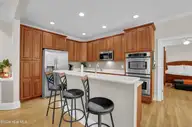 134 Wild Berry Lane, Hampstead, NC 28443 — 5-bedroom waterfront home in Bent Tree, Hampstead, NC, photo 9 of 46: Kitchen