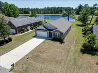 2021 Caracara Drive, New Bern, NC 28560 — 4-bedroom waterfront home in Fairfield Harbour, New Bern, NC, photo 2 of 65: 2021 Caracara Dr. with pond view