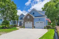 497 Broomsedge Court SE, Bolivia, NC 28422 — 4-bedroom waterfront home in Winding River Plantation, Bolivia, NC, photo 2 of 60: Front of home and garage
