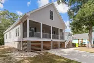 101 SW 28th Street, Oak Island, NC 28465 — 5-bedroom home in Pinners Point, Oak Island, NC, photo 4 of 56: Full Screened Porch