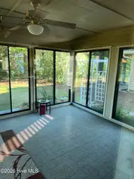 515 Fairway Drive W, Sunset Beach, NC 28468 — 3-bedroom home in Sea Trail Plantation, Sunset Beach, NC, photo 17 of 25: Carolina room from living room
