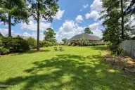 1226 Atrium Way, Leland, NC 28451 — 3-bedroom waterfront home in Waterford of the Carolinas, Leland, NC, photo 2 of 61: Rear Exterior