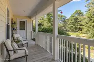 3254 Island Drive SE, Bolivia, NC 28422 — 3-bedroom waterfront home in River Run Plantation, Bolivia, NC, photo 8 of 70: Side Porch 1