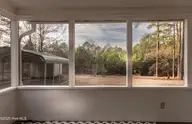 142 Pine Valley Lane, West End, NC 27376 — 2-bedroom waterfront manufactured home in Pine Vly Sub, West End, NC, photo 21 of 24: 251217-142PineValleybackyard-8467-HDR