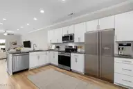 229 Cline Way Unit 104, Beaufort, NC 28516 — 3-bedroom townhome in 1809 Live Oak, Beaufort, NC, photo 4 of 44: Open Concept Kitchen and Living