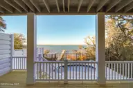 3804 Emerald Drive E, Emerald Isle, NC 28594 — 4-bedroom waterfront townhome in Emerald Isle By The Sea, Emerald Isle, NC, photo 23 of 46: Covered Porch off of bedroom