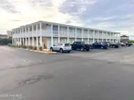 Ocean Sands, Atlantic Beach — 1-bedroom waterfront condo in Ocean Sands, Atlantic Beach, NC, photo 7 of 40: PAVED BUILDING PARKING AT BUILDING A