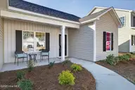 9579 Lily Pond Court NE, Leland, NC 28451 — 3-bedroom home in Lily Pond, Leland, NC, photo 4 of 33: Covered front porch