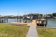 213 W Bogue Sound Drive, Atlantic Beach, NC 28512 — 3-bedroom waterfront home in Sound View Isles, Atlantic Beach, NC, photo 4 of 50: Dock with boat lift