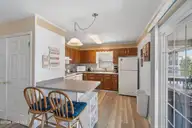 411 5th Street, Sunset Beach, NC 28468 — 4-bedroom home, Sunset Beach, NC, photo 8 of 50: Kitchen with Bar Seating