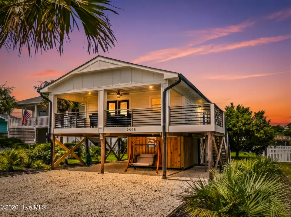 2508 E Beach Drive, Oak Island, NC 28465 — 3-bedroom waterfront home in Long Beach, Oak Island, NC, photo 1 of 62: DJI_20250809115038_0054_D-Edit_twilight_