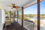 1404 W Yacht Drive, Oak Island, NC 28465 — 3-bedroom waterfront home in Pinners Point, Oak Island, NC, photo 11 of 46: Screened in porch