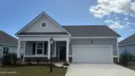 1222 Woodhouse Drive NW, Ash, NC 28420 — 4-bedroom home in Brunswick Plantation, Ash, NC, photo 1 of 26: Lot 21 - 1222 Woodhouse Drive