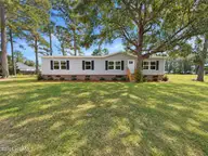 809 Garner Drive, Newport, NC 28570 — 3-bedroom manufactured home in River Woods, Newport, NC, photo 1 of 12: Ai enhanced front of 809 Garner