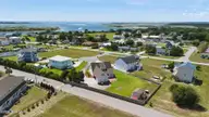 105 Franklin Court, Cedar Point, NC 28584 — 3-bedroom waterfront home in Cedar Point Beach, Cedar Point, NC, photo 5 of 53: 5 Back of home and yard aerial view