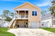 135 NE 75th Street, Oak Island, NC 28465 — 4-bedroom home in Tranquil Harbor, Oak Island, NC, photo 1 of 37: Front
