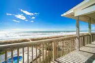 1819 Salter Path Road, Indian Beach, NC 28512 — 5-bedroom waterfront home in Roosevelt Estate, Indian Beach, NC, photo 15 of 58: Open & covered porch overlooks beach
