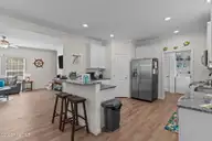 101 SW 28th Street, Oak Island, NC 28465 — 5-bedroom home in Pinners Point, Oak Island, NC, photo 15 of 56: Kitchen Open to Living Room