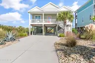 1020 W Pelican Drive, Oak Island, NC 28465 — 3-bedroom waterfront home in W. Long Beach, Oak Island, NC, photo 1 of 47: 1020 W Pelican