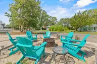316 NE 52nd Street, Oak Island, NC 28465 — 3-bedroom home in Tranquil Harbor, Oak Island, NC, photo 13 of 49: 7_fire pit