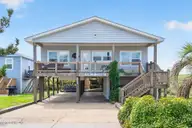 6011 W Beach Drive, Oak Island, NC 28465 — 4-bedroom waterfront home in Long Beach, Oak Island, NC, photo 1 of 68