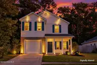 1022 Lake Norman Lane, Leland, NC 28451 — 4-bedroom home in Lake Forest Village, Leland, NC, photo 2 of 36: 1022LakeNormanLane-2_Dusk