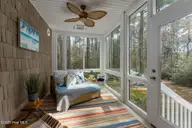 205 E Loon Court, Hampstead, NC 28443 — 3-bedroom home in Pelican Reef, Hampstead, NC, photo 16 of 68: screen-porch-01a