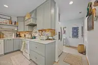 111 Mimosa Boulevard, Pine Knoll Shores, NC 28512 — 3-bedroom waterfront home in Pine Knoll Association, Pine Knoll Shores, NC, photo 8 of 54: Kitchen & Entry to Laundry Room