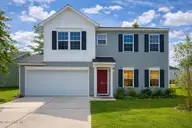 1439 Judith Drive SE, Bolivia, NC 28422 — 3-bedroom home in New South Bridge, Bolivia, NC, photo 1 of 54: Suburban home at dusk with lush yard