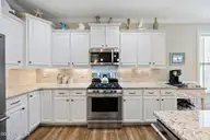 6988 Ascension Drive SW, Ocean Isle Beach, NC 28469 — 3-bedroom home in Sunset Ridge, Ocean Isle Beach, NC, photo 11 of 37: Granite/gas cooktop