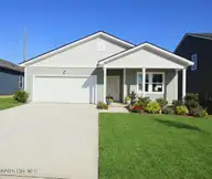 307 Currents Place SE 07401, Bolivia, NC 28422 — 4-bedroom home in Ocean Pointe, Bolivia, NC, photo 1 of 11: front-ai with flowers