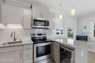 213 W Bogue Sound Drive, Atlantic Beach, NC 28512 — 3-bedroom waterfront home in Sound View Isles, Atlantic Beach, NC, photo 9 of 50: Kitchen with bar seating