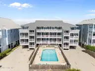 1308 Carolina Beach Avenue N Apt 3c, Carolina Beach, NC 28428 — 3-bedroom waterfront condo in Reefs, Carolina Beach, NC, photo 1 of 44: 2-web-or-mls-DJI_20250825104748_0045_D